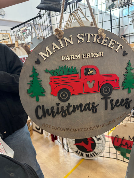 Main Street Christmas trees round sign